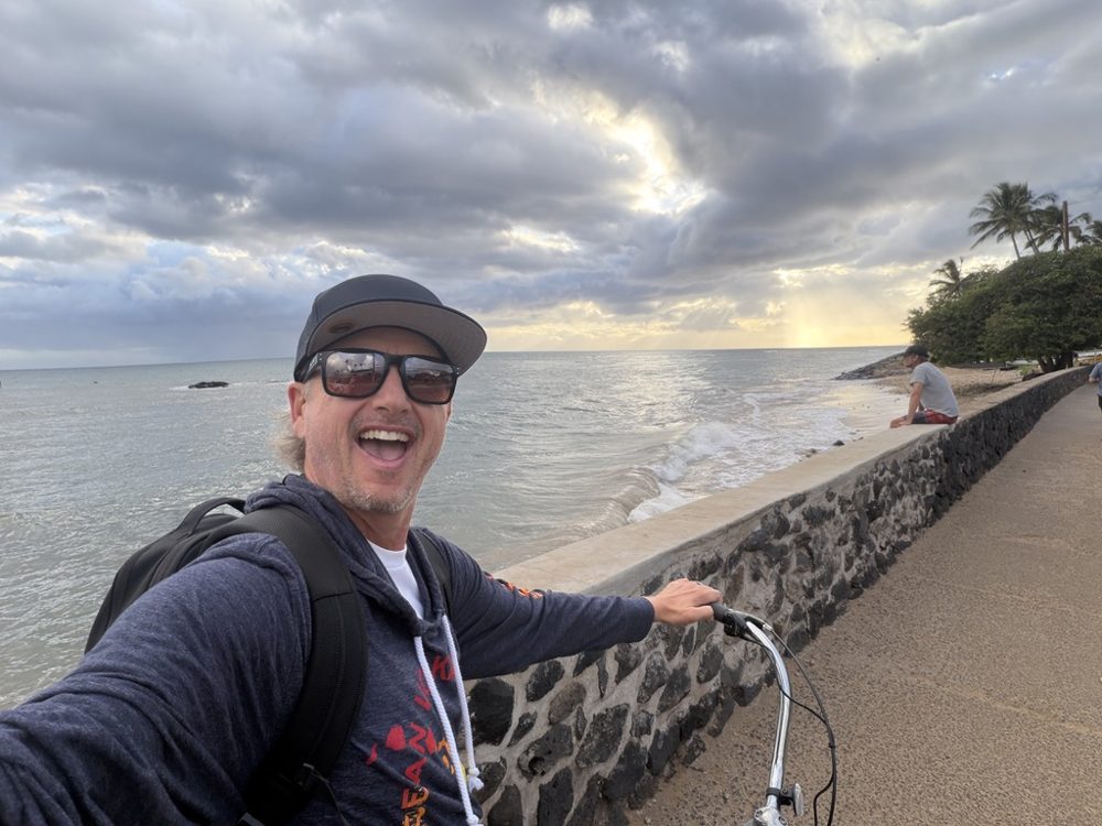Jeff Igoe riding his bike along the water in Maui